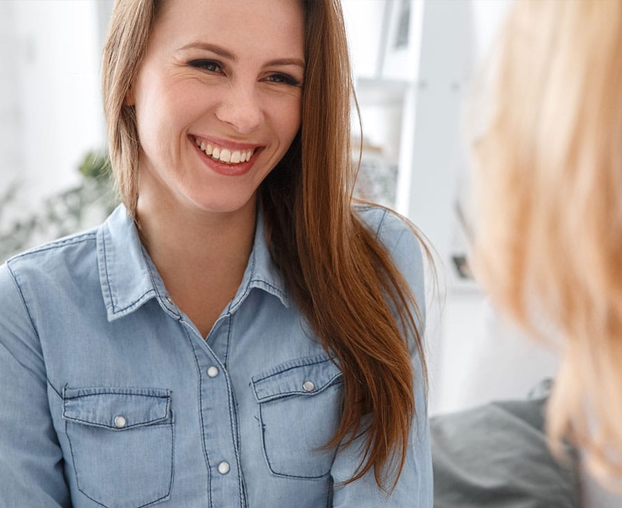 smiling woman talking to a clinician