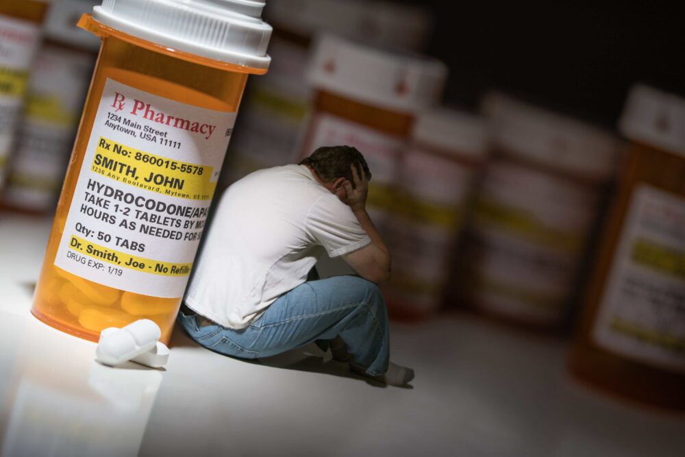 depressed man struggling with opioid addiction