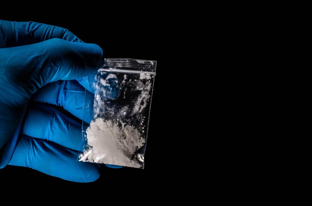 hand holding dangerous fentanyl with gloves